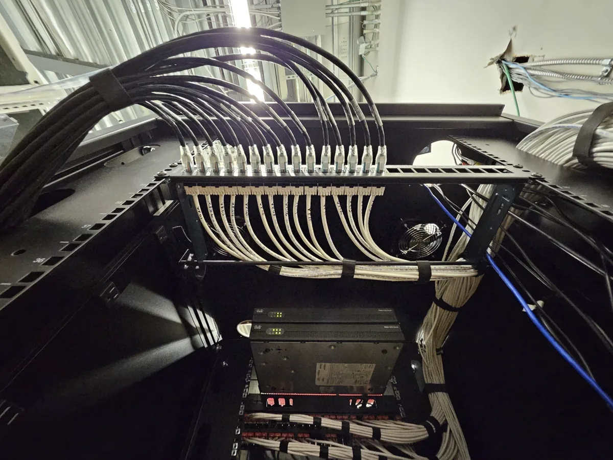 Low-voltage network rack with patch panel and neatly dressed cabling